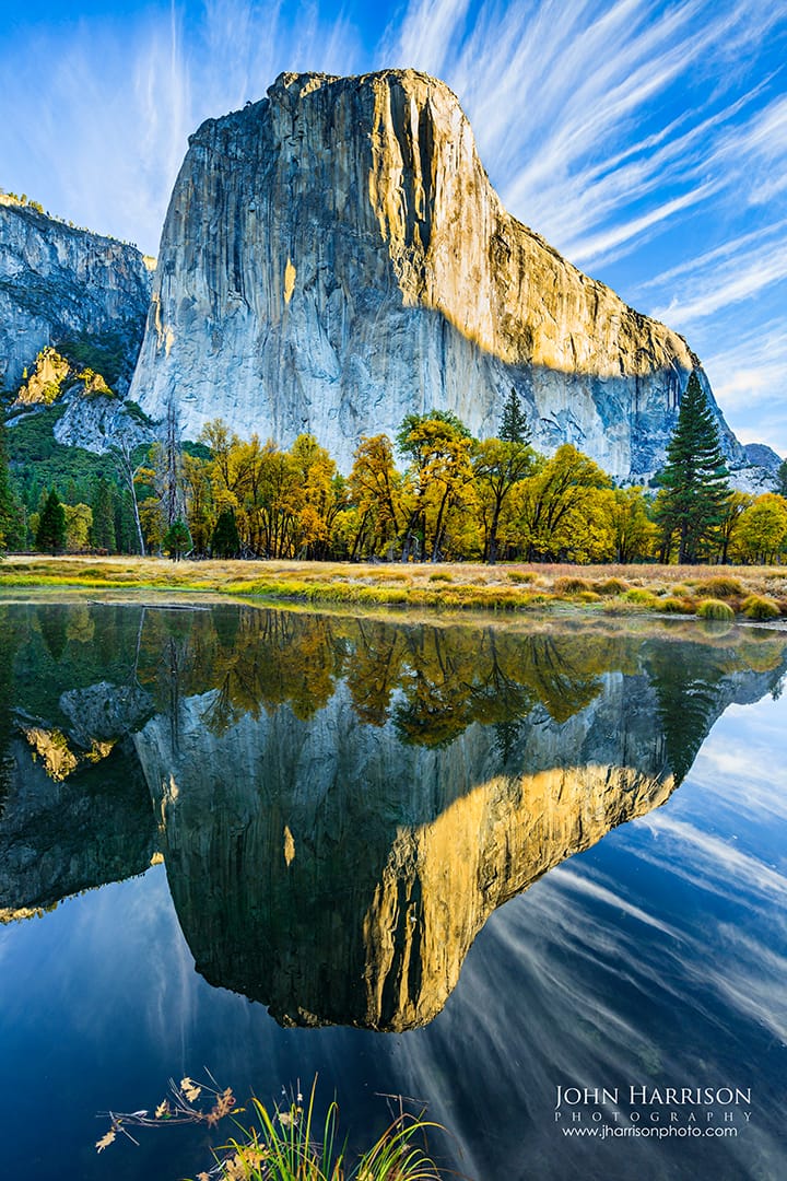 El Capitan reflected in the calm waters of the Merced River on a clear day in Yosemite National Park, California
