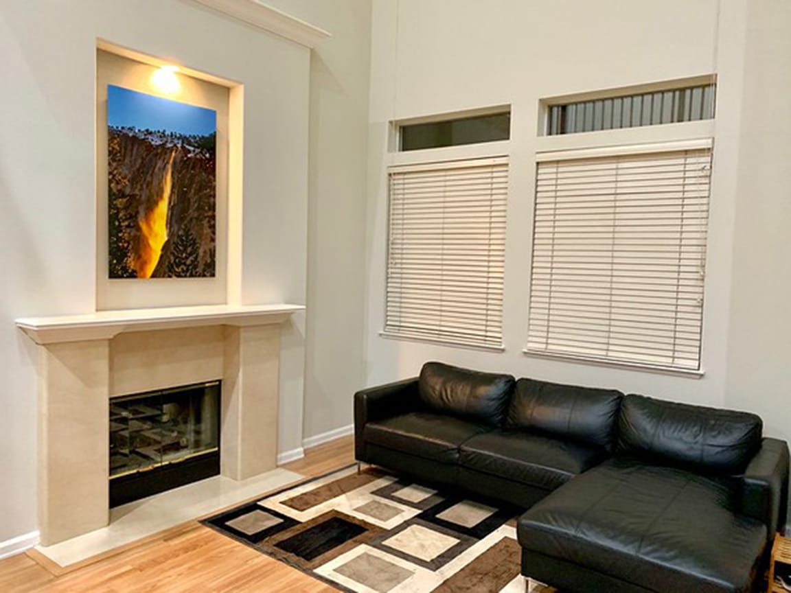 Nature’s Firefall by John Harrison displayed in a private collector’s home, featuring Horsetail Falls Firefall on El Capitan at sunset in Yosemite National Park