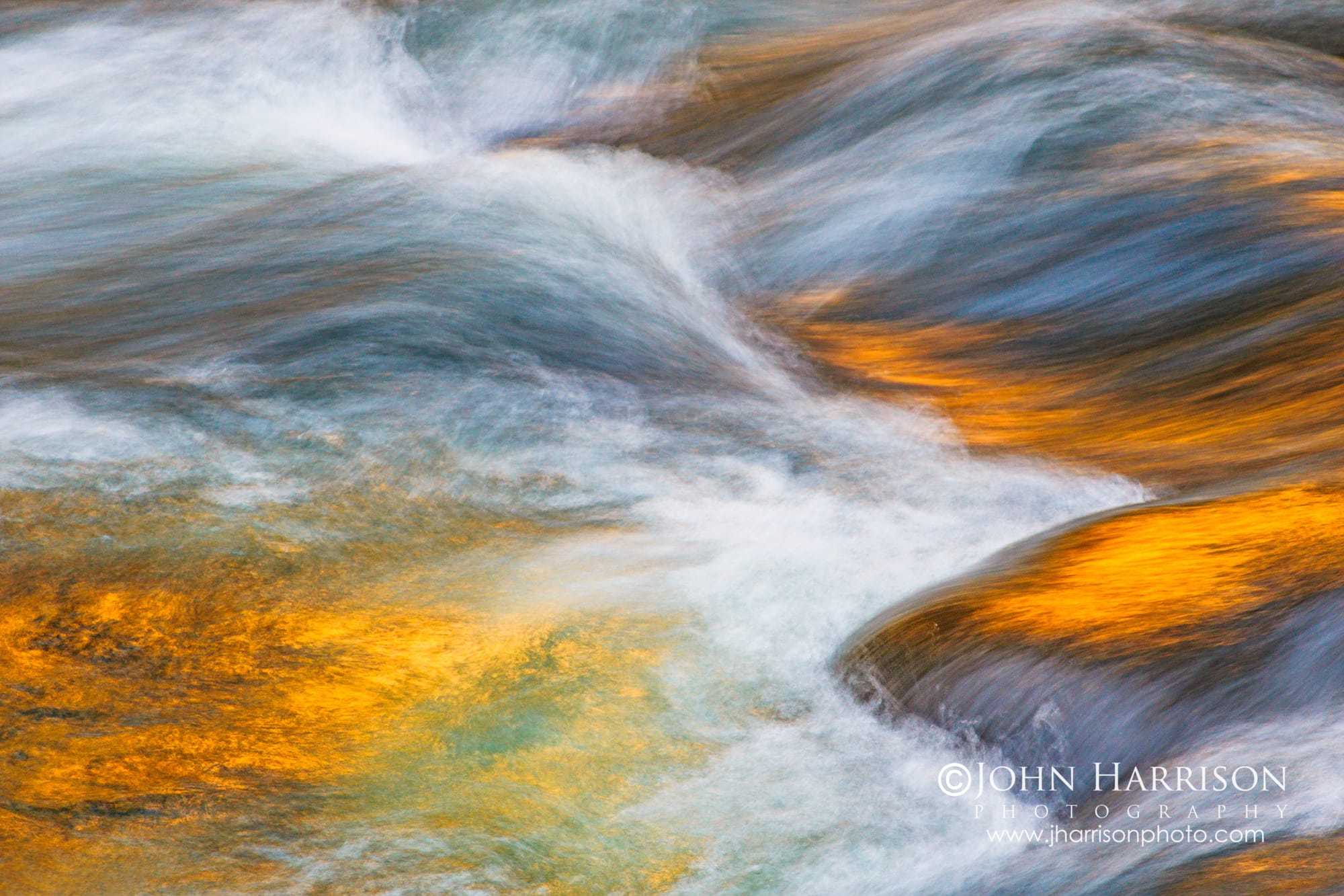 Fine Art Photography of the golden sunset light painting the flowing Merced River in Yosemite Valley, abstract water textures and granite reflections in soft motion, Yosemite National Park