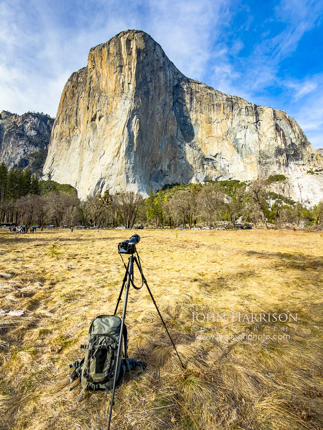 Photographer setup with tripod and camera facing El Capitan in Yosemite Valley at El Capitan Meadow in Yosemite National Park.