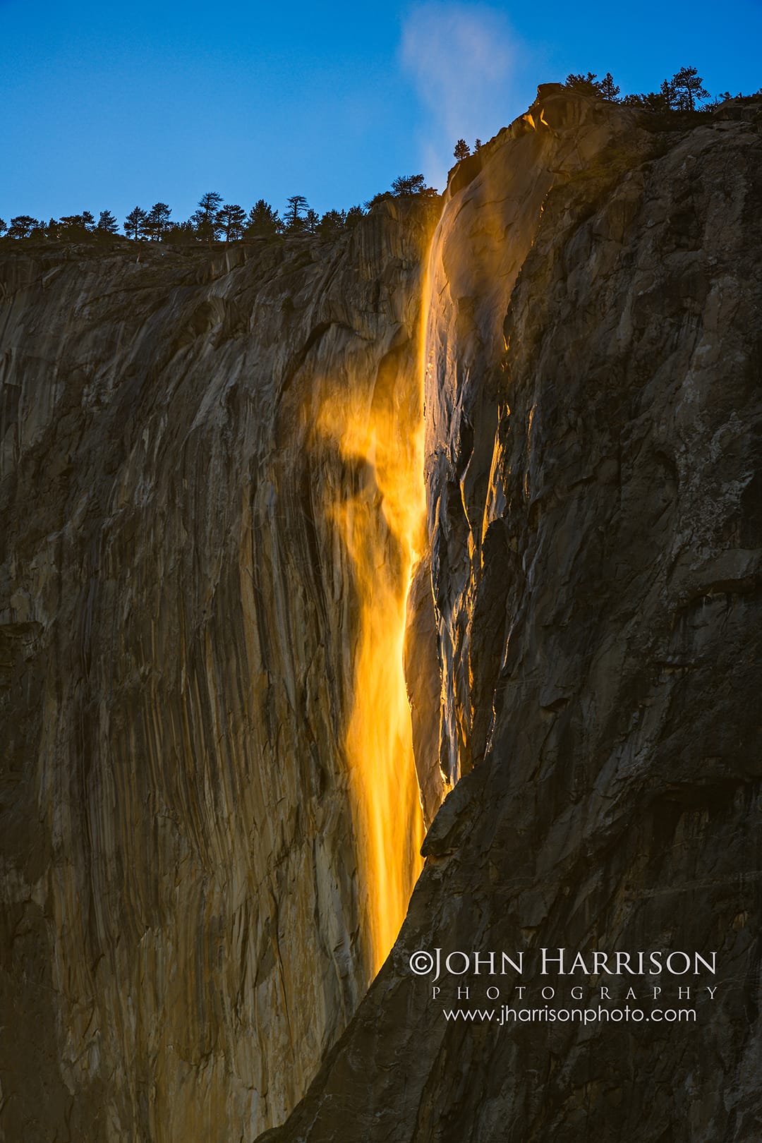 Yosemite Firefall glowing on Horsetail Fall as sunset light illuminates El Capitan in Yosemite National Park