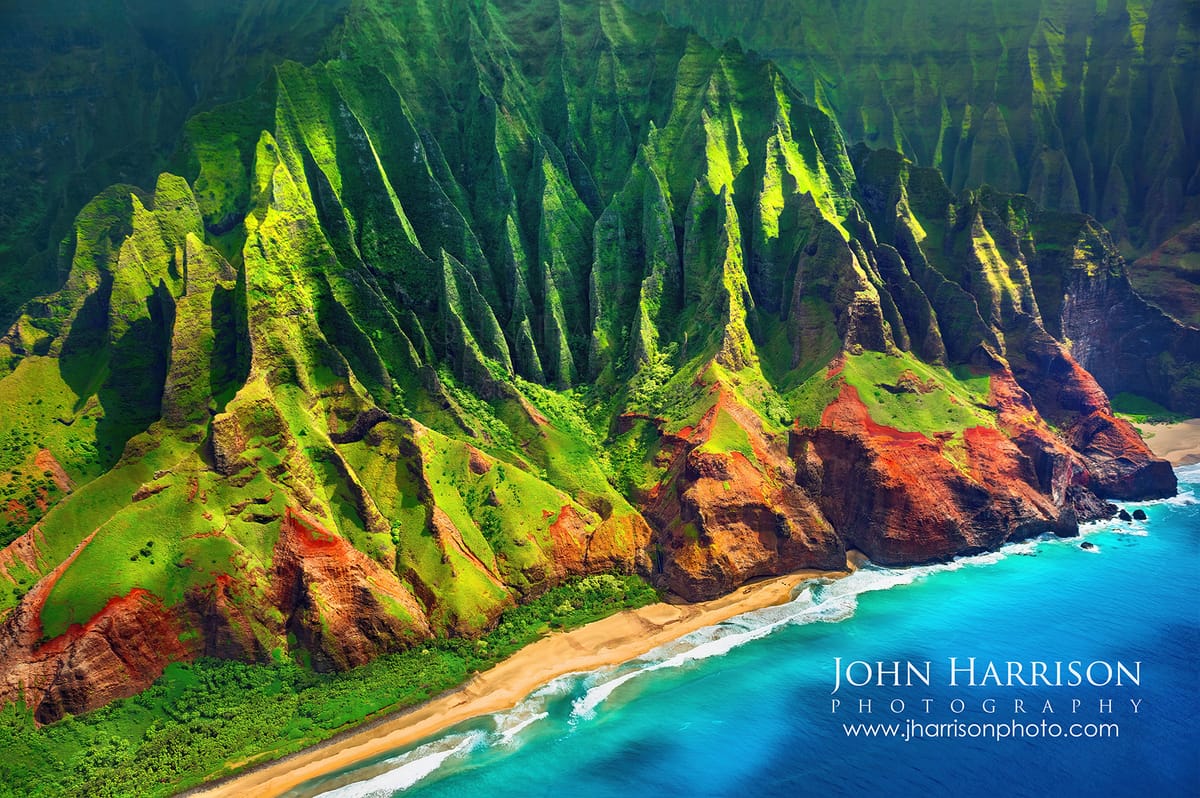 Aerial view of the dramatic Na Pali Coast cliffs on Kauai captured during a helicopter photography flight above Hawaii’s most iconic coastline.